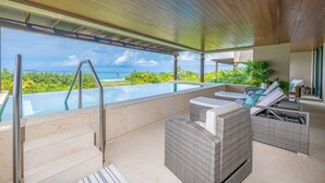 A rooftop infinity pool with a view of the ocean, outdoor seating area with wicker furniture, and a wooden ceiling structure. - Condo Balboa 3BD - Tau Punta Mita (Punta de Mita)
