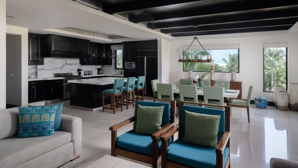 A modern interior with a kitchen, dining area, and seating space. - Condo Azalea 4BD - Hacienda De Mita (Punta de Mita)