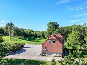 A red brick house with a gravel driveway and a lawn. - "Alkmar" - 6.5km from the sea by Interhome (Ørum Djurs)