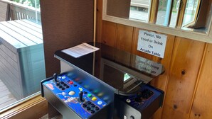 A pool table with a no food or drink sign on the wall.