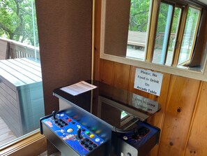 A pool table with a no food or drink sign on the wall.