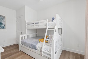 A bunk bed in a room with a door, a light switch, and a power outlet on the wall. - 158 E Garfield ave, unit 105 in the heart of Wildwood. Location parking and pool (Wildwood)
