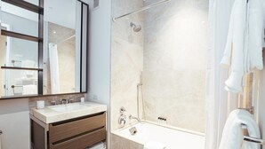 A modern bathroom with a glass-enclosed shower, a vanity with a sink, and a large mirror. - Landing Amazing Studio, Game Room, Gym (New Rochelle)