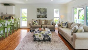 A spacious living room with a sofa set, a coffee table, and a dining area with chairs. - Private Siesta Key Pool Home Near Beaches - Siesta Sol (Sarasota)