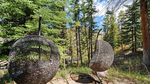 Two spherical sculptures in a forested area with a stone pathway. - Spacious 5BR Vail retreat with river views and fireplace (Vail)
