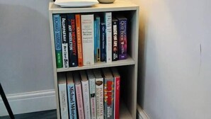 A corner bookshelf with a lamp and a potted plant. - #43 Digbeth Private Studio Apart (West Midlands)