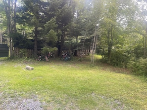 A grassy outdoor area with a wooden fence and trees.