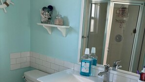 A bathroom with a toilet, sink, and mirror. - 2-bedroom modular home in wonderful Long Key with beautiful ocean views/sunsets (Layton)