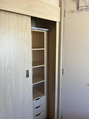A wooden wardrobe with multiple shelves and drawers. - #155 Cozy Caravan in Dinas Dinlle - Sleeps 6 (Dinas Dinlle)