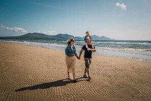 A sandy beach with a clear sky and distant mountains. - #155 Cozy Caravan in Dinas Dinlle - Sleeps 6 (Dinas Dinlle)