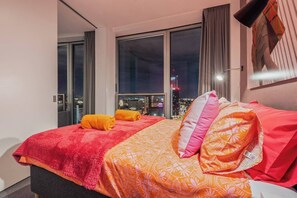 A hotel room with a city view, a bed with patterned bedding, and a large window. - #25 World Famous Rotunda 18th floor skyline views (West Midlands)