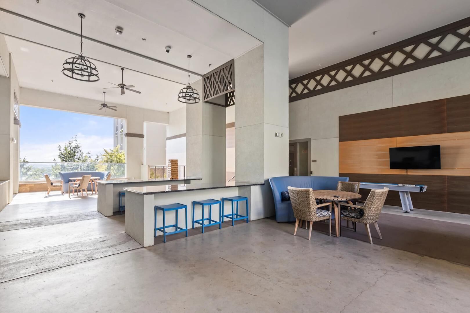 A modern interior with a bar area, seating, and a TV.