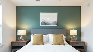 A hotel room with a bed, two bedside tables with lamps, a wall-mounted picture, and a window. - Landing Beautiful 1bd, Gym, Clubhouse (Houston)