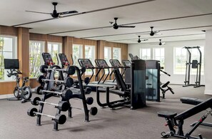 A gym with various exercise equipment, including treadmills, weight machines, and a rowing machine. - Landing Beautiful 1bd, Gym, Clubhouse (Port Charlotte)