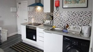 A compact kitchen with a dishwasher, a sink, and a microwave. - #68 Stylish Digbeth Studio 10 Apt City Centre (West Midlands)