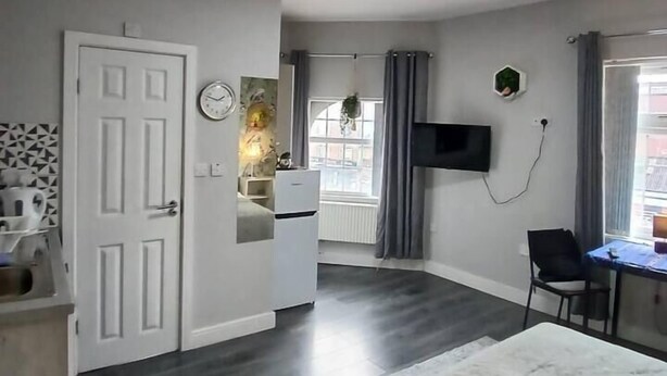 A modern room with a bed, a desk, a television, and a window with curtains. - #68 Stylish Digbeth Studio 10 Apt City Centre (West Midlands)