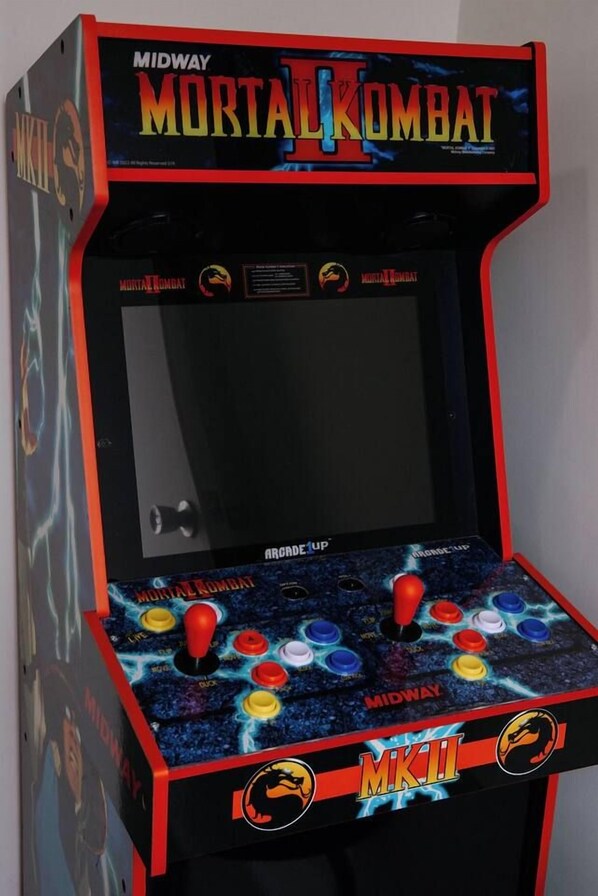 A Midway arcade game titled Mortal Kombat, featuring a joystick and button layout.