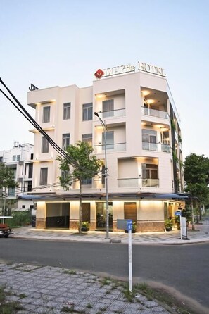 A multi-story hotel with a flat facade, balconies, and a sign indicating it is a hotel. - May The Hotel (Can Tho)