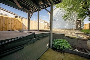 A covered outdoor area with a pool table, a wooden fence, and a house in the background. - 10 Min to Lucas Oil~Walk to Mass Ave~Hot Tub (Indianapolis)