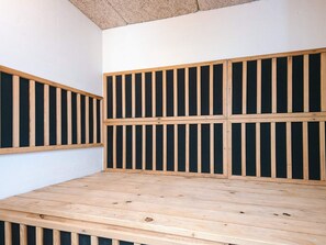 A room with a wooden floor, a white wall, and a ceiling with a textured material. - 4 Star Holiday Home in Ulfborg (Ulfborg)