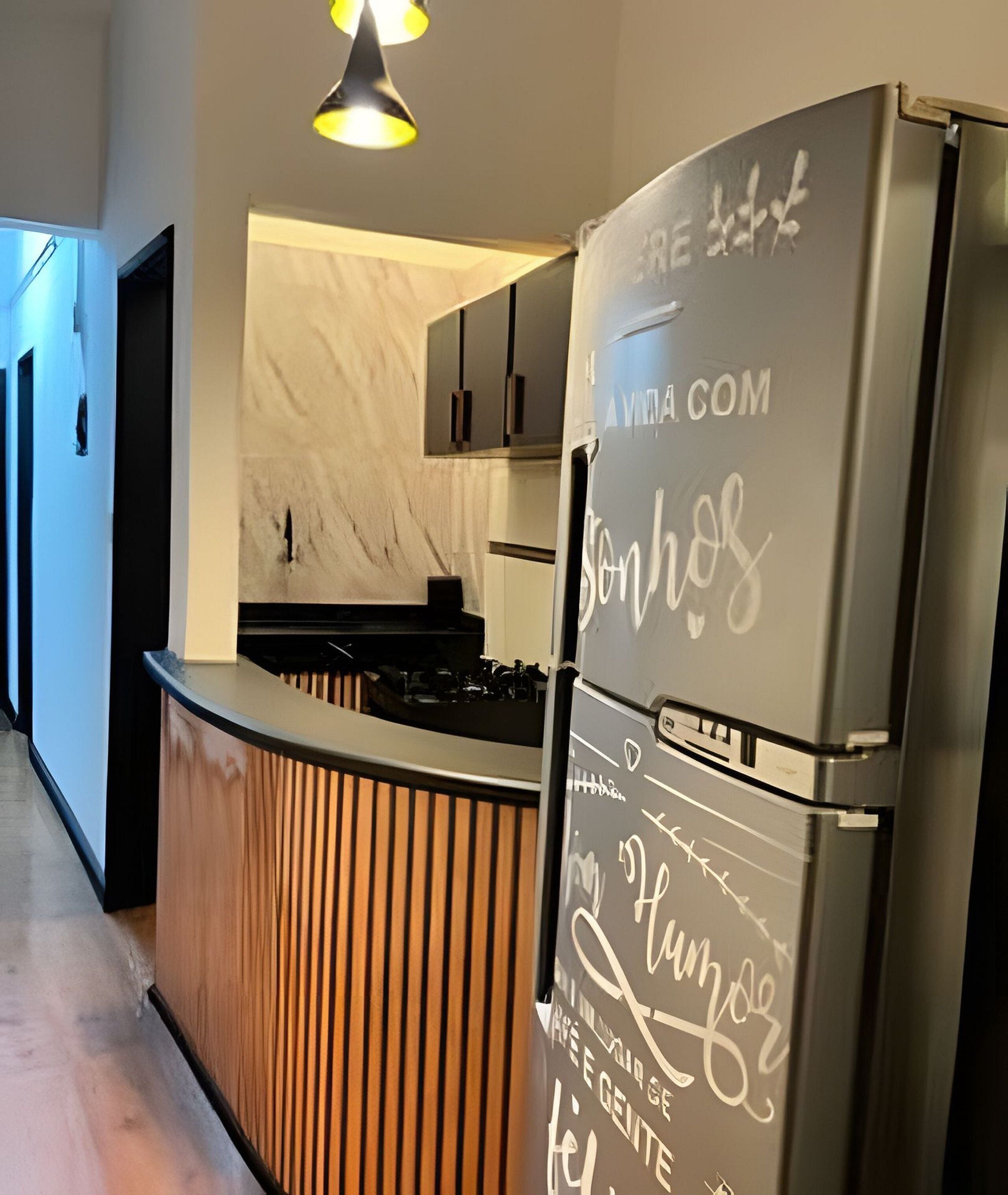 A modern kitchen with a built-in island, stainless steel appliances, and a marble backsplash.