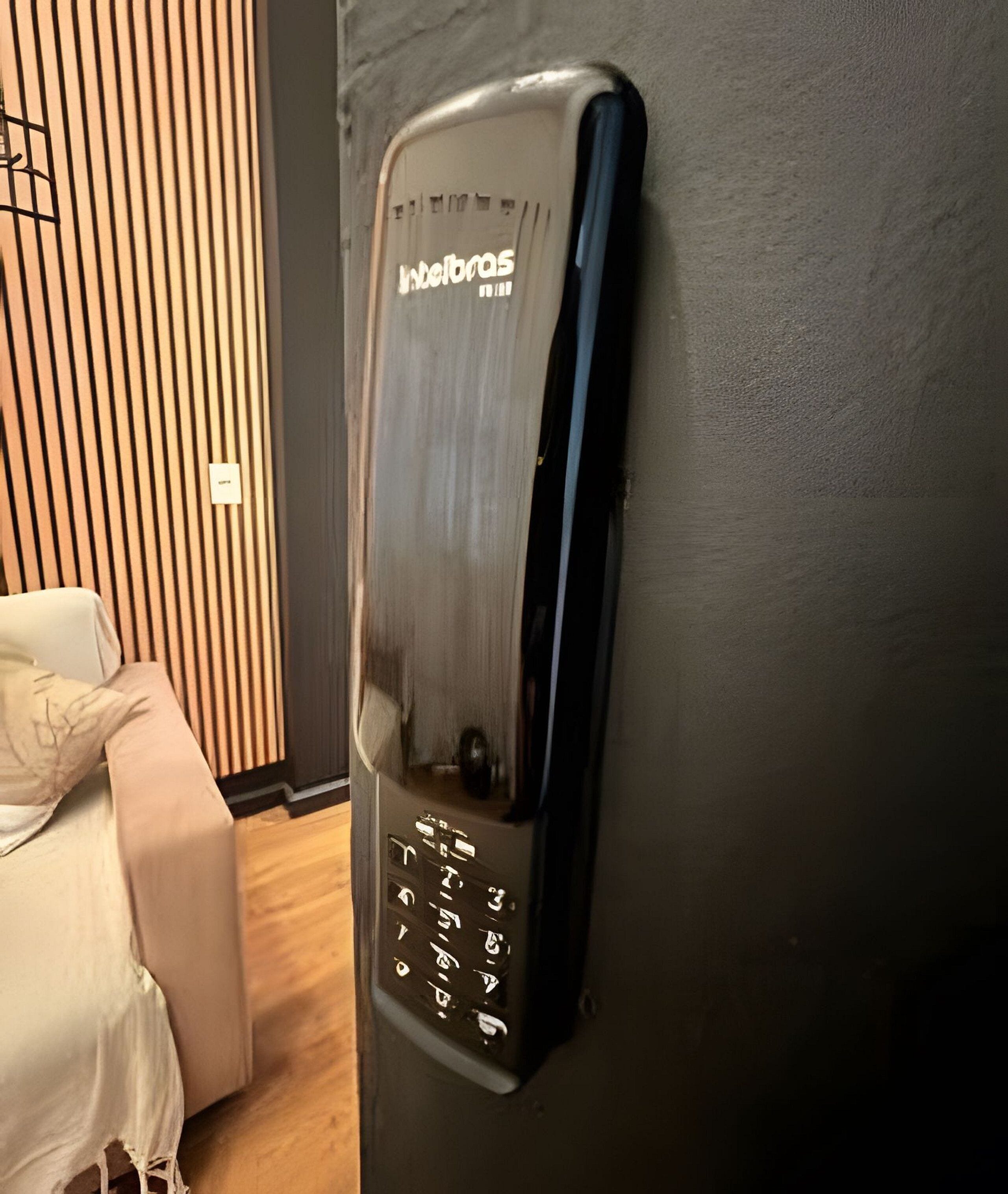 A wall-mounted elevator with a keypad and the brand name 'Wellsbro's' visible.