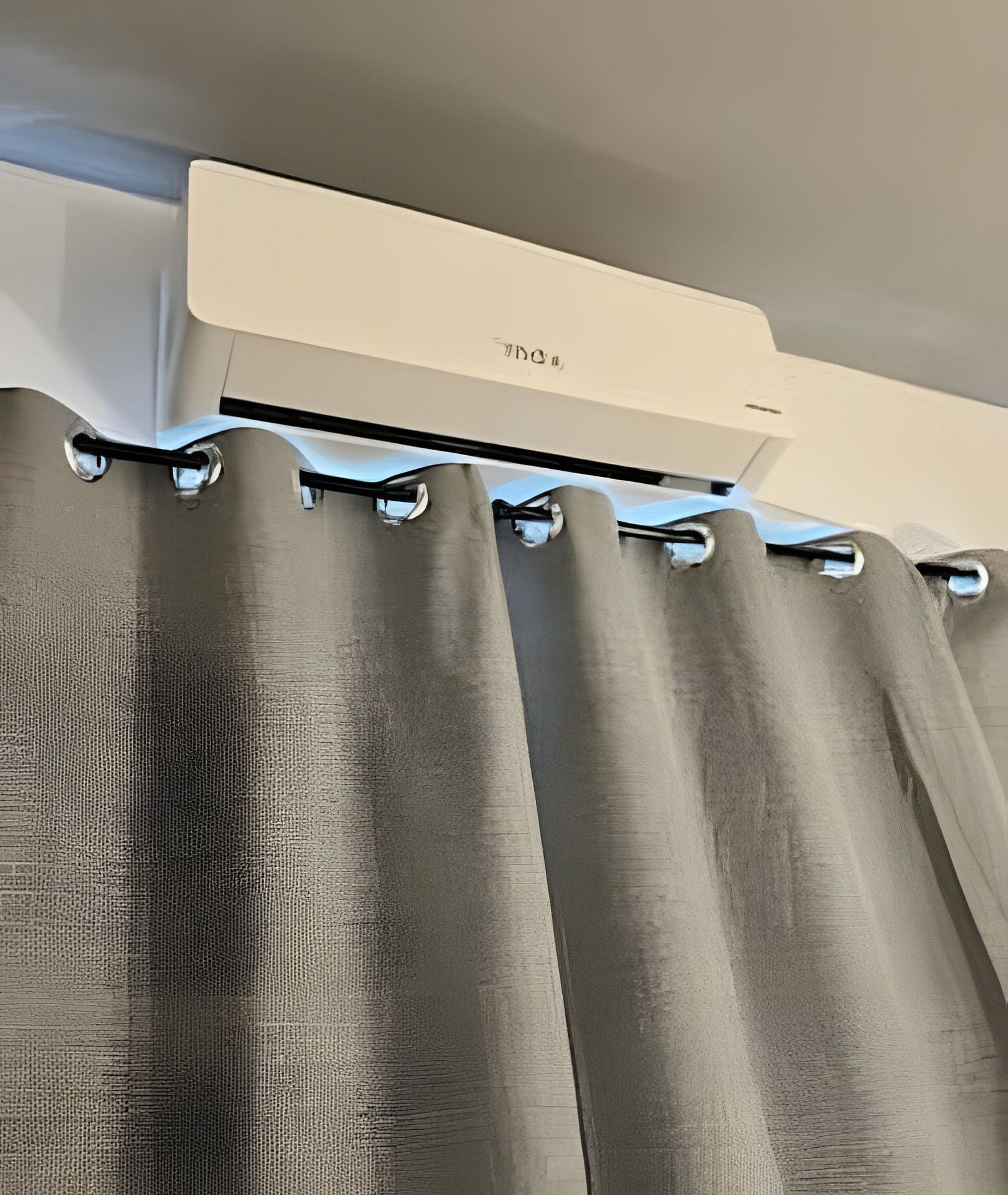 A ceiling-mounted air conditioning unit with a visible brand name.