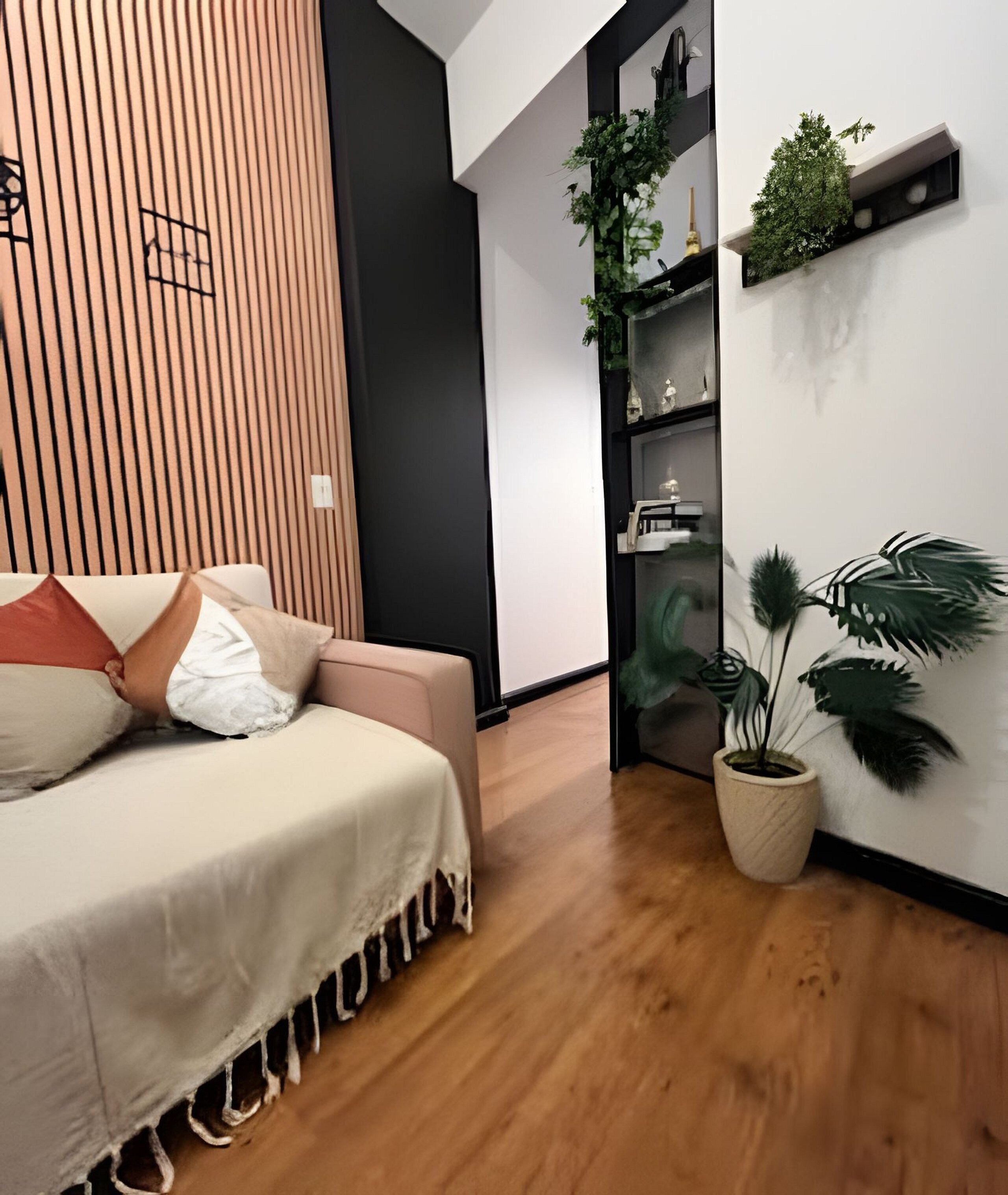 A modern bedroom with a bed, a wooden slat wall, a potted plant, and a shelf with decorative items.