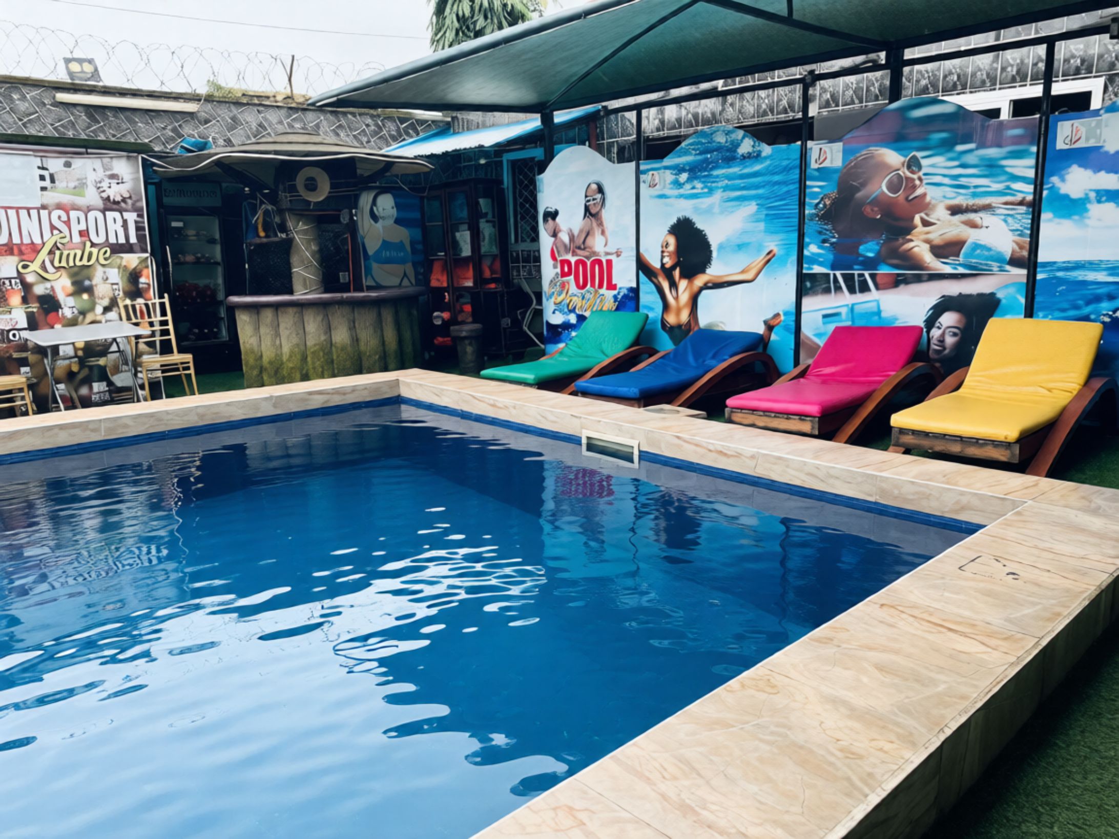 A swimming pool with lounge chairs and a bar area with a poolside seating arrangement.
