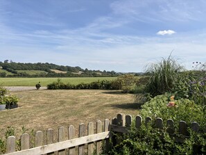 A rural landscape with a wooden fence, a field, and rolling hills in the distance. - Ashclose Lodge Annexe -  Sherborne, Dorset (Sherborne)