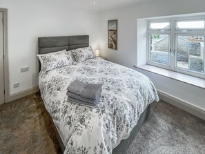 A bedroom with a bed, a window with a view, and a wall-mounted artwork. - 2 bedroom accommodation in Hamsterley, near Bishop Auckland (Hamsterley, near Bishop Auckland)