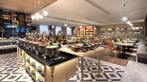A buffet area with multiple serving stations, a variety of food items, and a modern interior design. - Hampton by Hilton Beijing Dahongmen (Beijing)