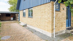 A two-story building with a blue exterior and a brick facade. - 6 Person Holiday Home in Stokkemarke (Stokkemarke)