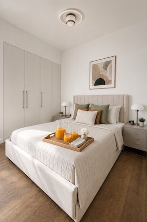 A bedroom with a bed, bedside tables, a nightstand, a wall-mounted artwork, and a ceiling light. - AC 2 Bed Stylish Covent Garden Flat | Central London (London)