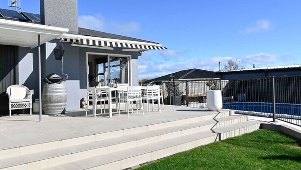 A patio with outdoor furniture, a barbecue grill, and a swimming pool. - Pool & Spa - Havelock North (Havelock North)
