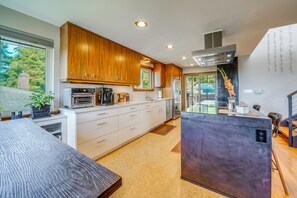 A modern kitchen with wooden cabinets, stainless steel appliances, and a central island. - 1/2 Mi to Alki Beach + Puget Sound Views! (Seattle)