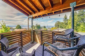 A wooden deck with outdoor furniture and a view of the ocean. - 1/2 Mi to Alki Beach + Puget Sound Views! (Seattle)