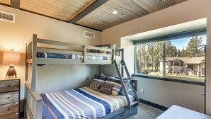 A bunk bed with a ladder, a desk, and a window with a view of houses and trees. - Renovated Tahoe Keys Getaway Near Lake & Heavenly (South Lake Tahoe)
