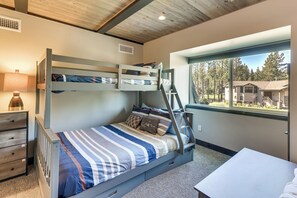 A bunk bed with a ladder, a desk, and a window with a view of houses and trees. - Renovated Tahoe Keys Getaway Near Lake & Heavenly (South Lake Tahoe)