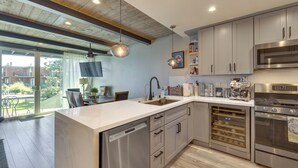 A modern kitchen with stainless steel appliances, a dishwasher, and a wine cooler. - Renovated Tahoe Keys Getaway Near Lake & Heavenly (South Lake Tahoe)