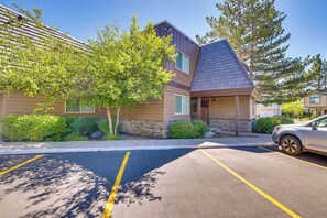 A building with a sloped roof, a parking lot with marked spaces, and a tree in front. - Renovated Tahoe Keys Getaway Near Lake & Heavenly (South Lake Tahoe)