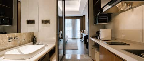 A modern bathroom with a large sink, mirror, and shower.