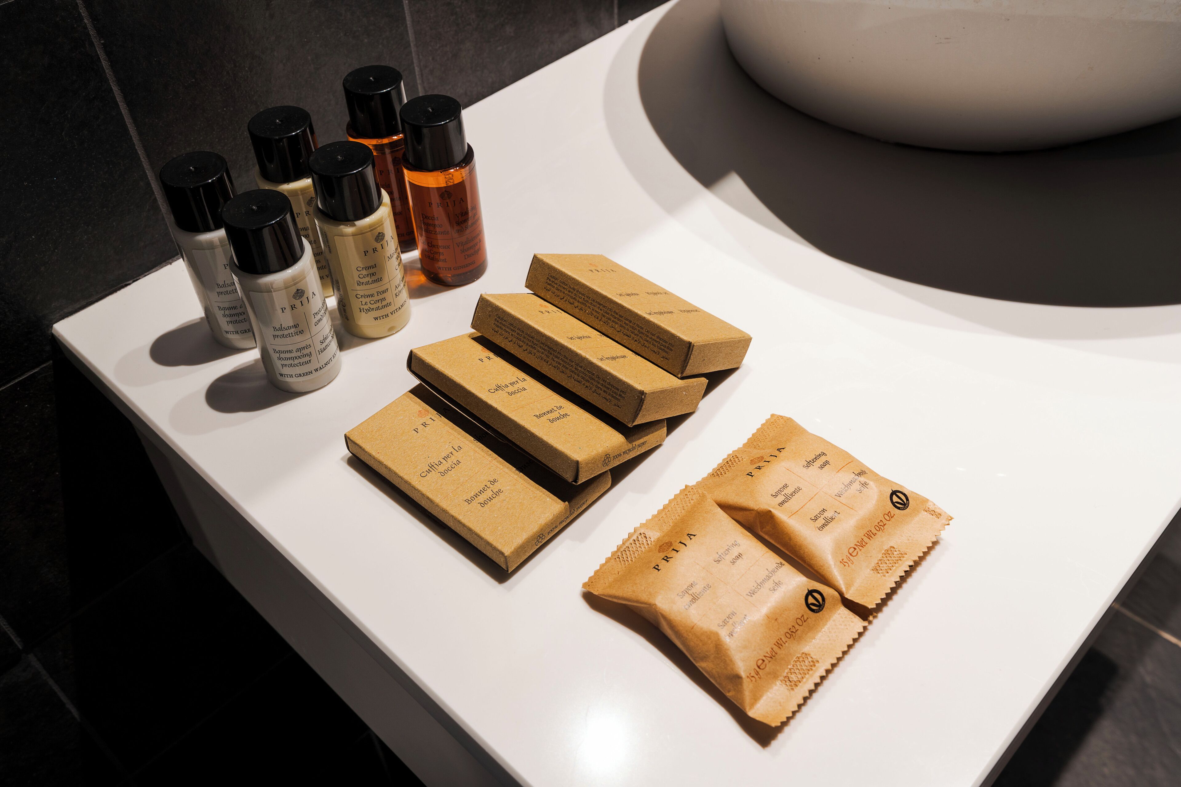 A bathroom counter with various toiletries and packaged products.