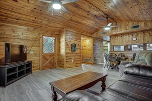 A wooden interior with a dining area, a sofa, and a television. - Boat Dock & Ramp! Brazos River Couple’s Retreat (Granbury)