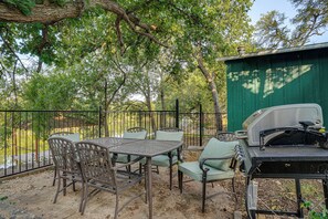 An outdoor patio with a grill, metal chairs, and a table. - Boat Dock & Ramp! Brazos River Couple’s Retreat (Granbury)