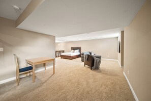 A bedroom with a bed, a desk, and a chair. - < 1 Mi to Geist Park & Beach! Playroom & Patio (McCordsville)