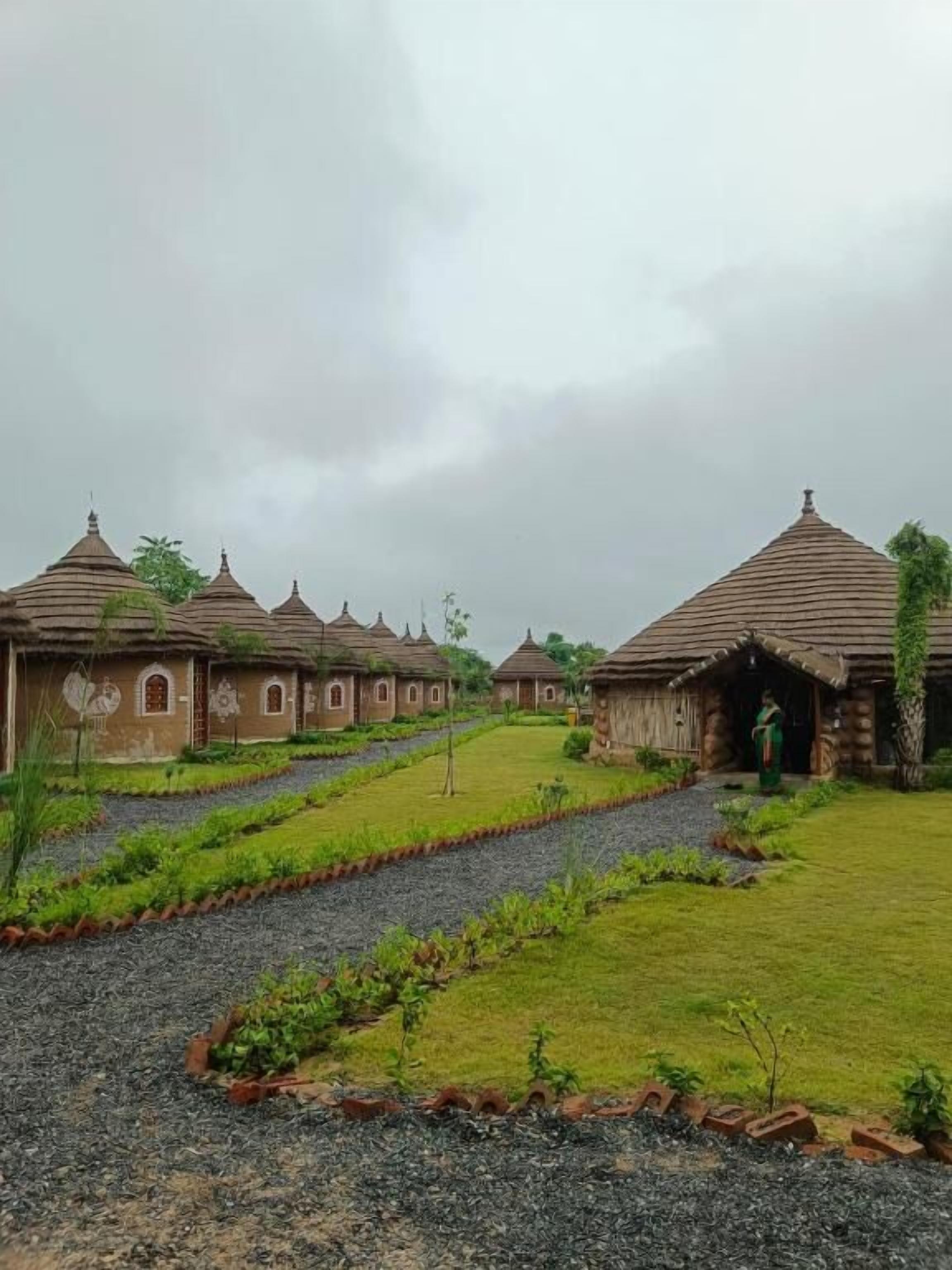 A series of traditional buildings with a central pathway leading to a larger structure.