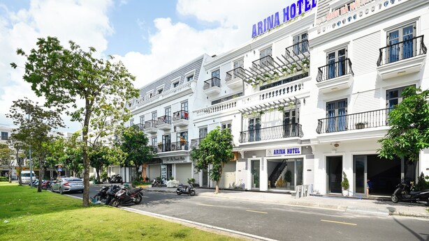 A hotel with a sign reading "ARINA HOTEL" and a visible entrance.