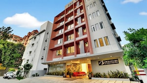 A multi-story hotel with a modern facade, a visible entrance with a reception area, and a sign indicating the name 'Westside Studios & Apart Hotel'. - Westside Studio & Apart Hotel (Hyderabad)