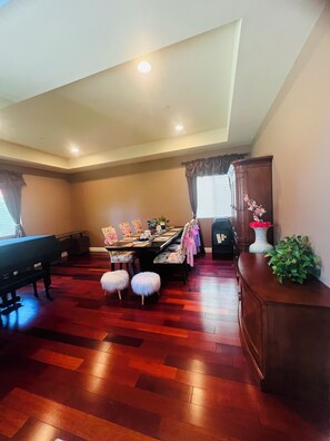 A dining area with a piano, a long table with chairs, and a cabinet with a plant. - Luxury 6BR Superb High End Spacious Cozy High Ceiling Arcadia Los Angeles (Monrovia)